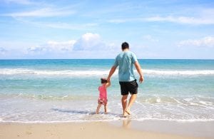 father with his child on a beach